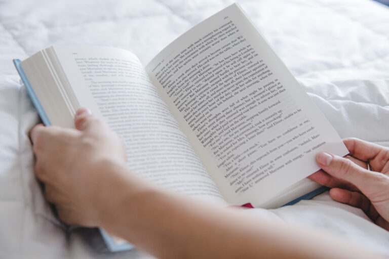 brazos-con-libro-en-la-cama